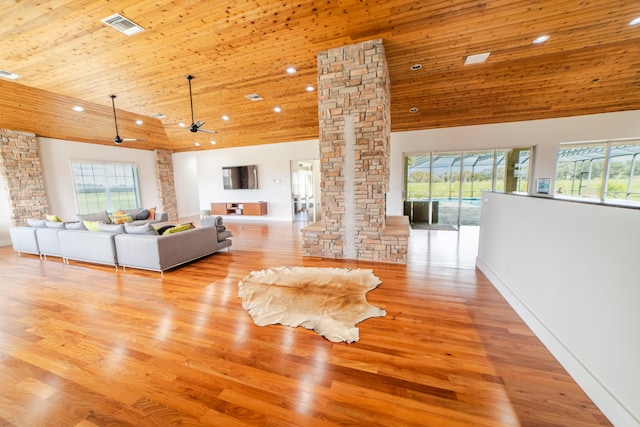 unfurnished living room featuring decorative columns, high vaulted ceiling, light hardwood / wood-style floors, and wood ceiling