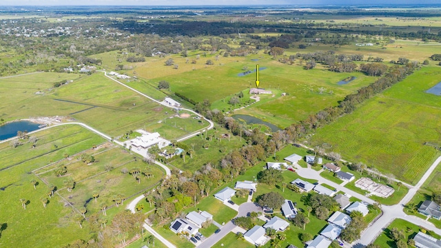 birds eye view of property featuring a rural view and a water view