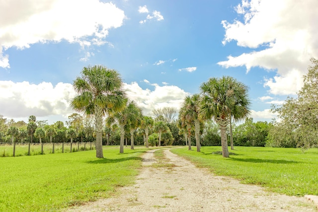 view of property's community featuring a rural view and a lawn