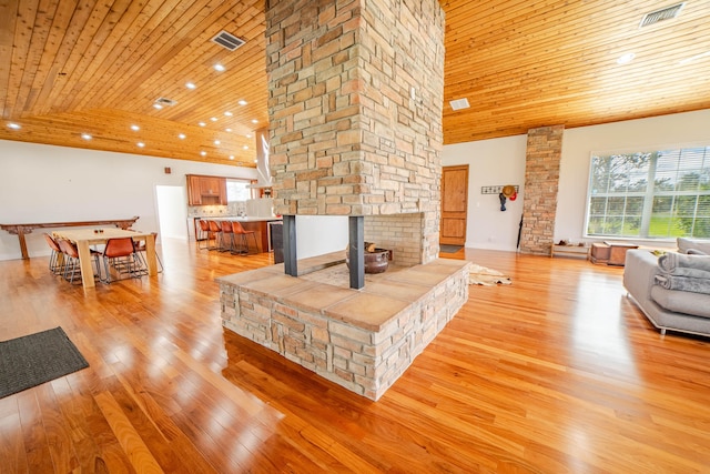 living room with high vaulted ceiling, light hardwood / wood-style flooring, and wood ceiling