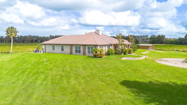 back of property with a yard and cooling unit