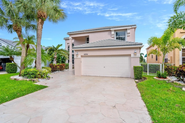 mediterranean / spanish-style home featuring a garage and a front yard