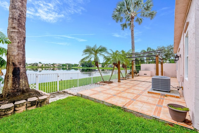 view of yard featuring cooling unit, a water view, and a patio