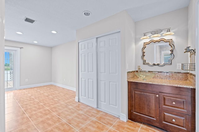 bathroom featuring tile patterned flooring and vanity