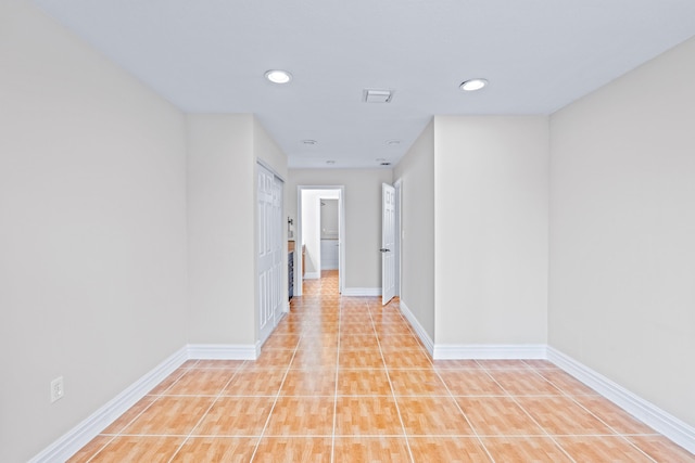 corridor with light tile patterned floors