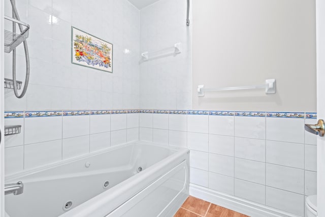 bathroom featuring toilet and tile walls