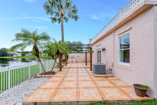 view of patio featuring a pergola, a water view, and central air condition unit