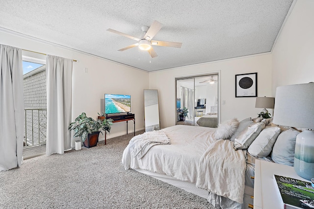 carpeted bedroom featuring ceiling fan, a textured ceiling, a closet, and ornamental molding