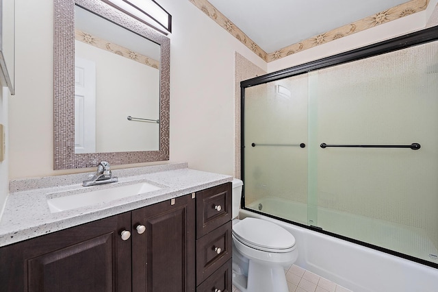 full bathroom featuring tile patterned flooring, vanity, combined bath / shower with glass door, and toilet