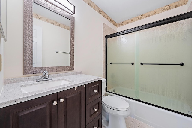 full bathroom featuring toilet, vanity, bath / shower combo with glass door, and tile patterned flooring