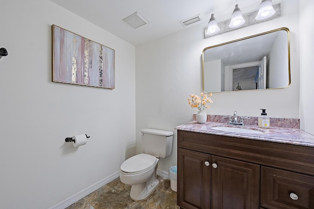 bathroom with toilet, baseboards, and vanity