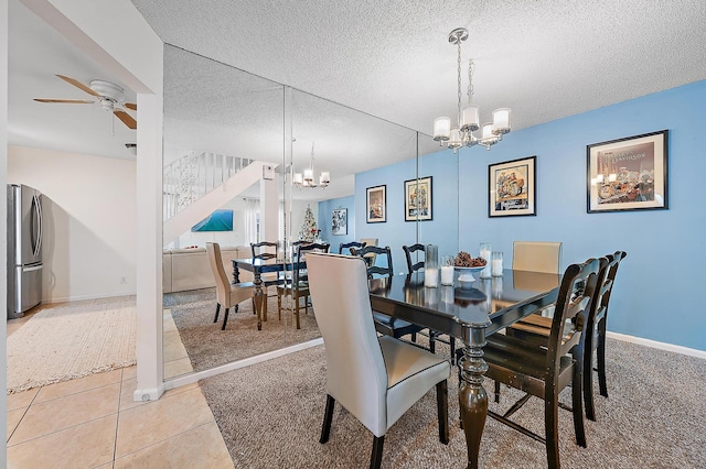 dining space featuring a chandelier, a ceiling fan, stairs, light carpet, and a textured ceiling