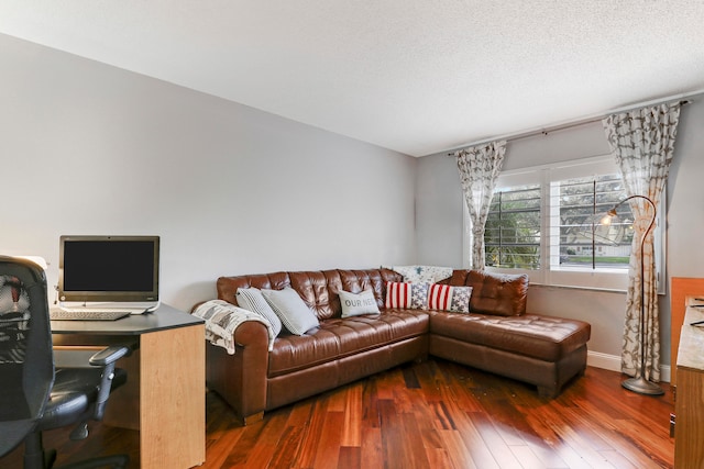 living room featuring dark hardwood / wood-style floors and a textured ceiling