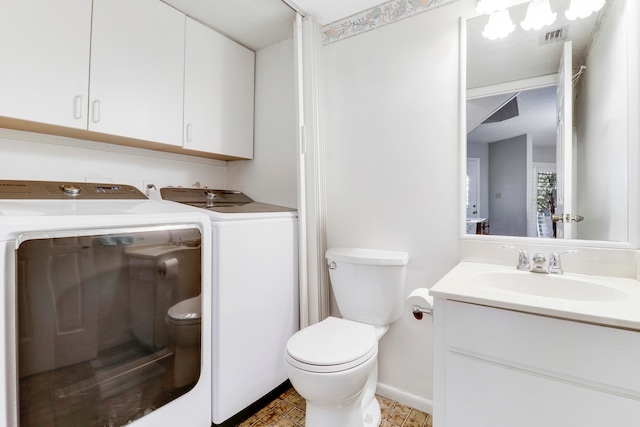 bathroom featuring vanity, toilet, and independent washer and dryer