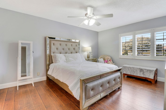 bedroom featuring wood-type flooring, ceiling fan, and a textured ceiling