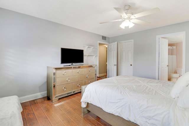 bedroom with ensuite bathroom, ceiling fan, and light hardwood / wood-style flooring