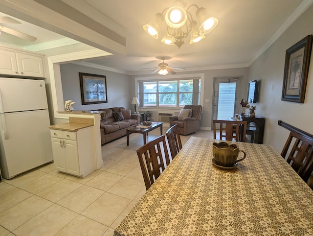 dining room with ceiling fan with notable chandelier, light tile patterned floors, and crown molding