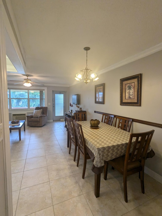 tiled dining area with ornamental molding and ceiling fan with notable chandelier