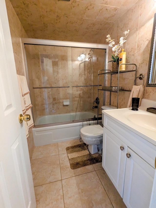 full bathroom featuring toilet, vanity, shower / bath combination with glass door, and tile patterned flooring