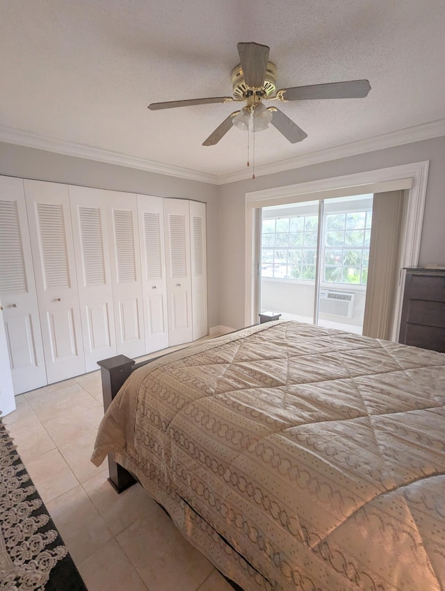 bedroom featuring light tile patterned flooring, a closet, ceiling fan, and crown molding