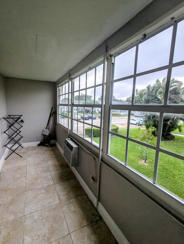 unfurnished sunroom with a wall mounted AC