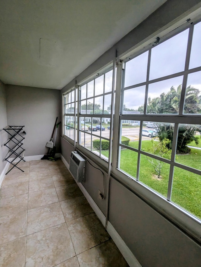 77 Andover C, West Palm Beach, FL 33417 - unfurnished sunroom featuring a wall unit AC