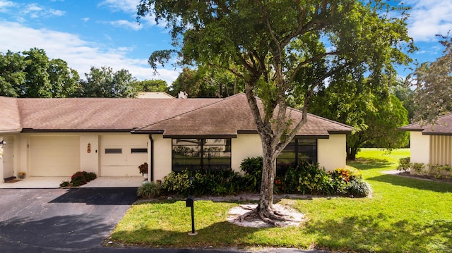 view of front of home with a garage and a front yard