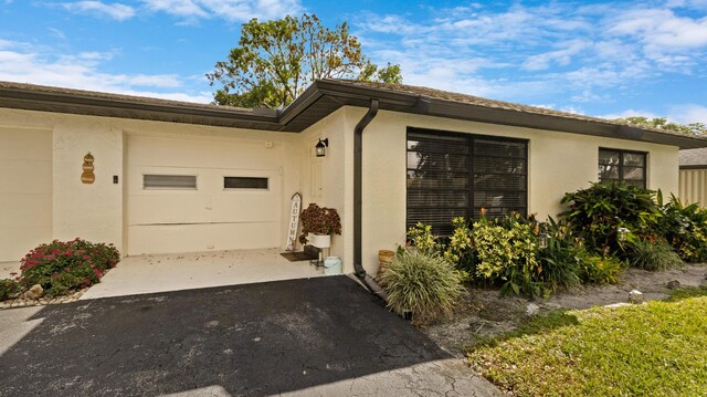 view of front of house with a front yard and a garage