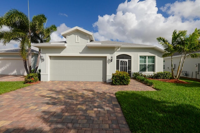 view of front of home with a garage and a front yard