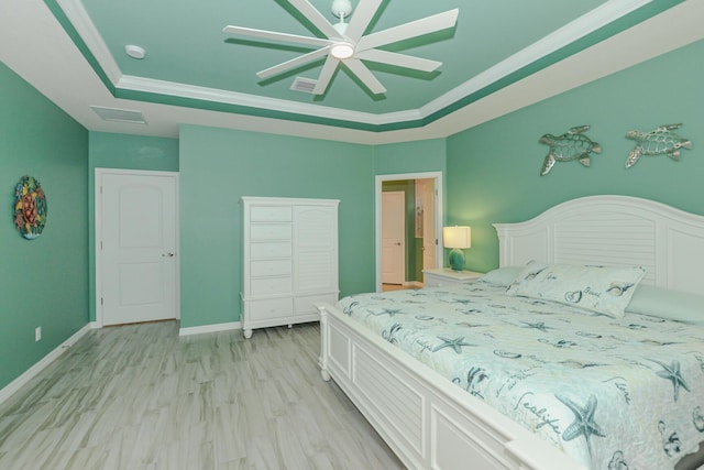 bedroom featuring a raised ceiling, ceiling fan, crown molding, and light hardwood / wood-style floors