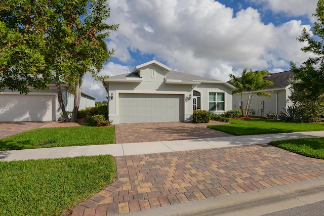 single story home with a garage and a front yard