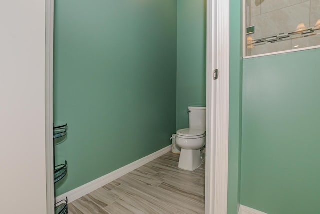 bathroom featuring hardwood / wood-style flooring and toilet