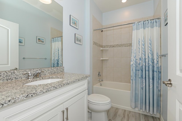 full bathroom featuring vanity, wood-type flooring, shower / bath combo, and toilet