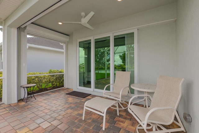 sunroom / solarium featuring ceiling fan