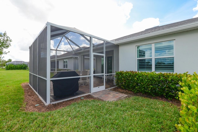 exterior space featuring a lanai and a yard