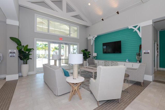 living room with french doors and high vaulted ceiling