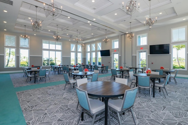 dining area featuring carpet, a towering ceiling, and coffered ceiling