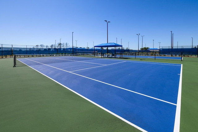 view of tennis court featuring basketball court