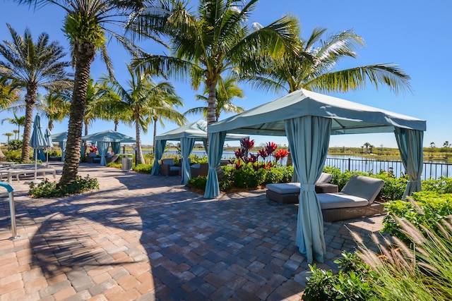 view of patio / terrace with a gazebo and a water view