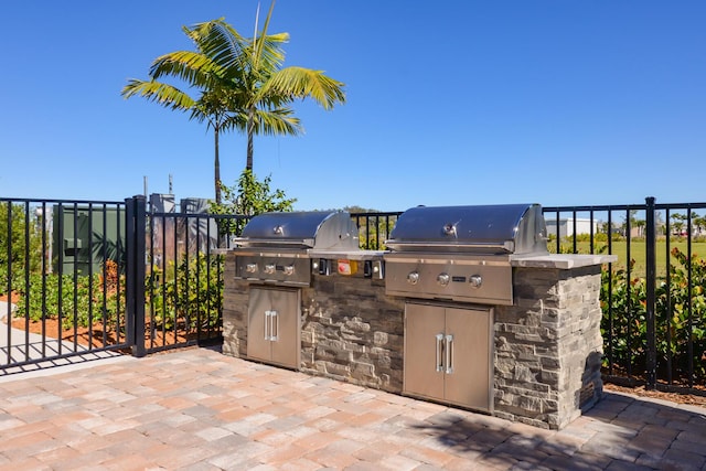 view of patio featuring area for grilling and a grill