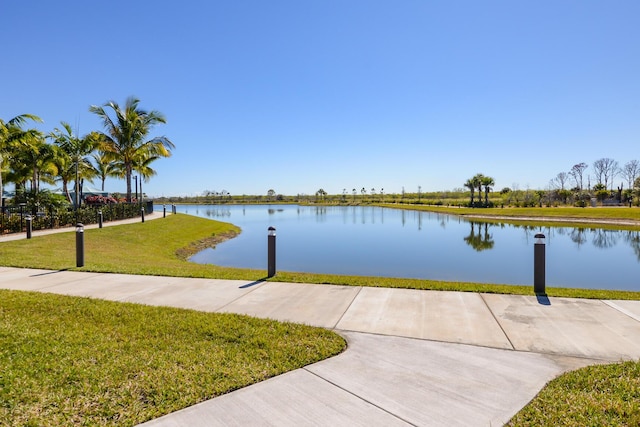 exterior space with a water view and a yard