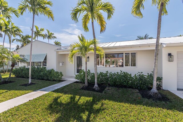 single story home with a front lawn and a garage