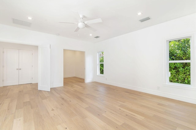 unfurnished room featuring ceiling fan and light hardwood / wood-style flooring