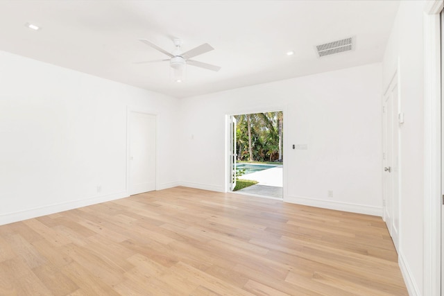 empty room featuring ceiling fan and light hardwood / wood-style floors