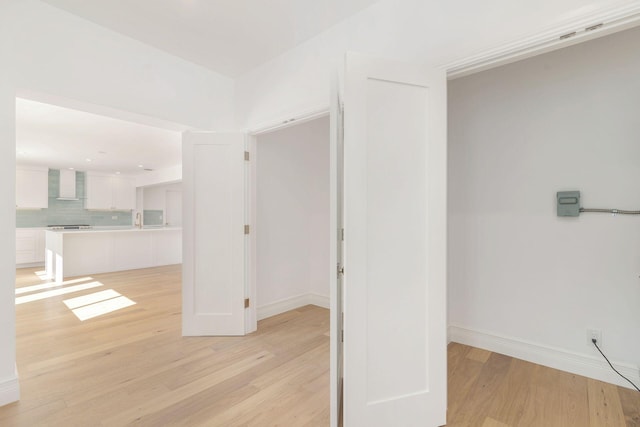 corridor with light hardwood / wood-style flooring