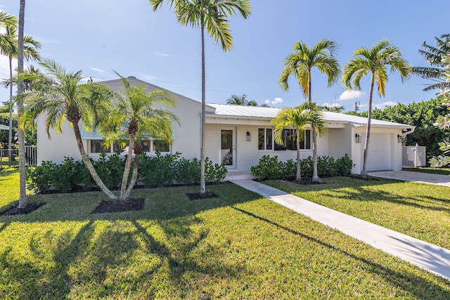 view of front of house with a garage and a front lawn