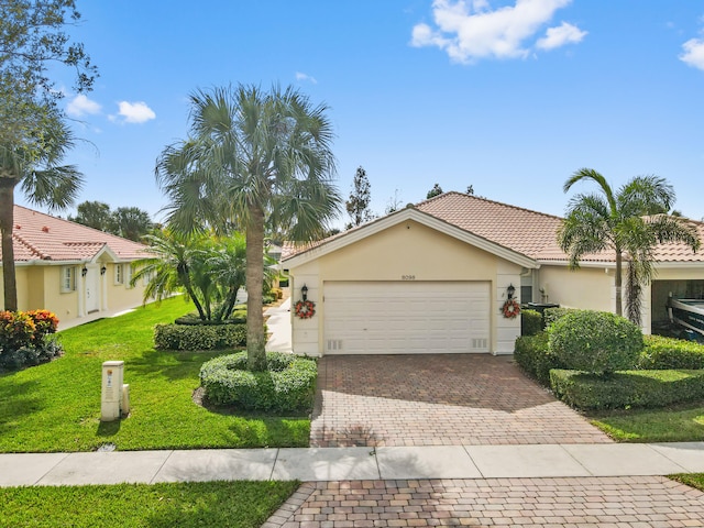 view of front of property with a front yard and a garage