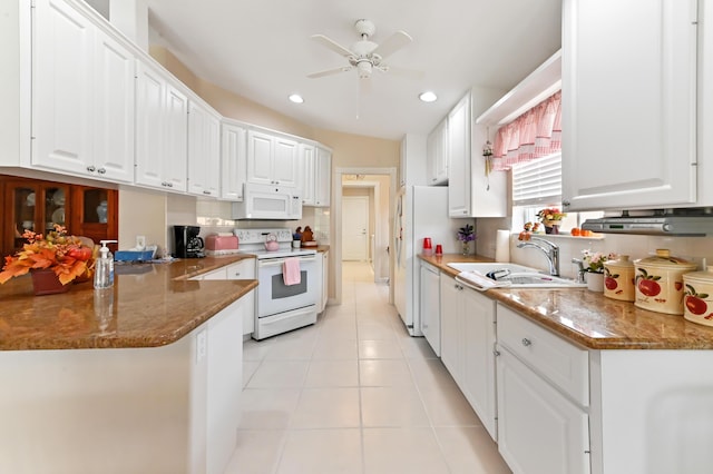 kitchen with kitchen peninsula, sink, white cabinetry, light tile patterned floors, and white appliances