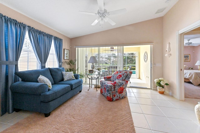 tiled living room featuring ceiling fan and vaulted ceiling