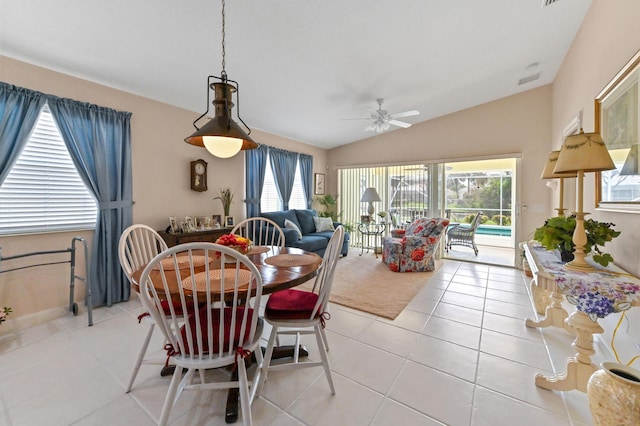 dining space with vaulted ceiling, ceiling fan, and light tile patterned floors